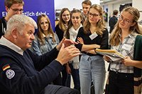 Ein Redner umzingelt von Zuhörern